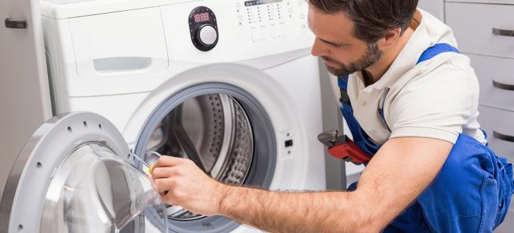 Handyman fixing a washing machine