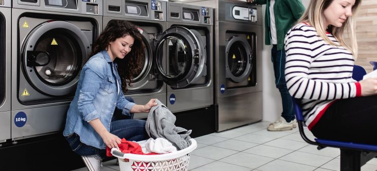 Young people at laundromat shop.